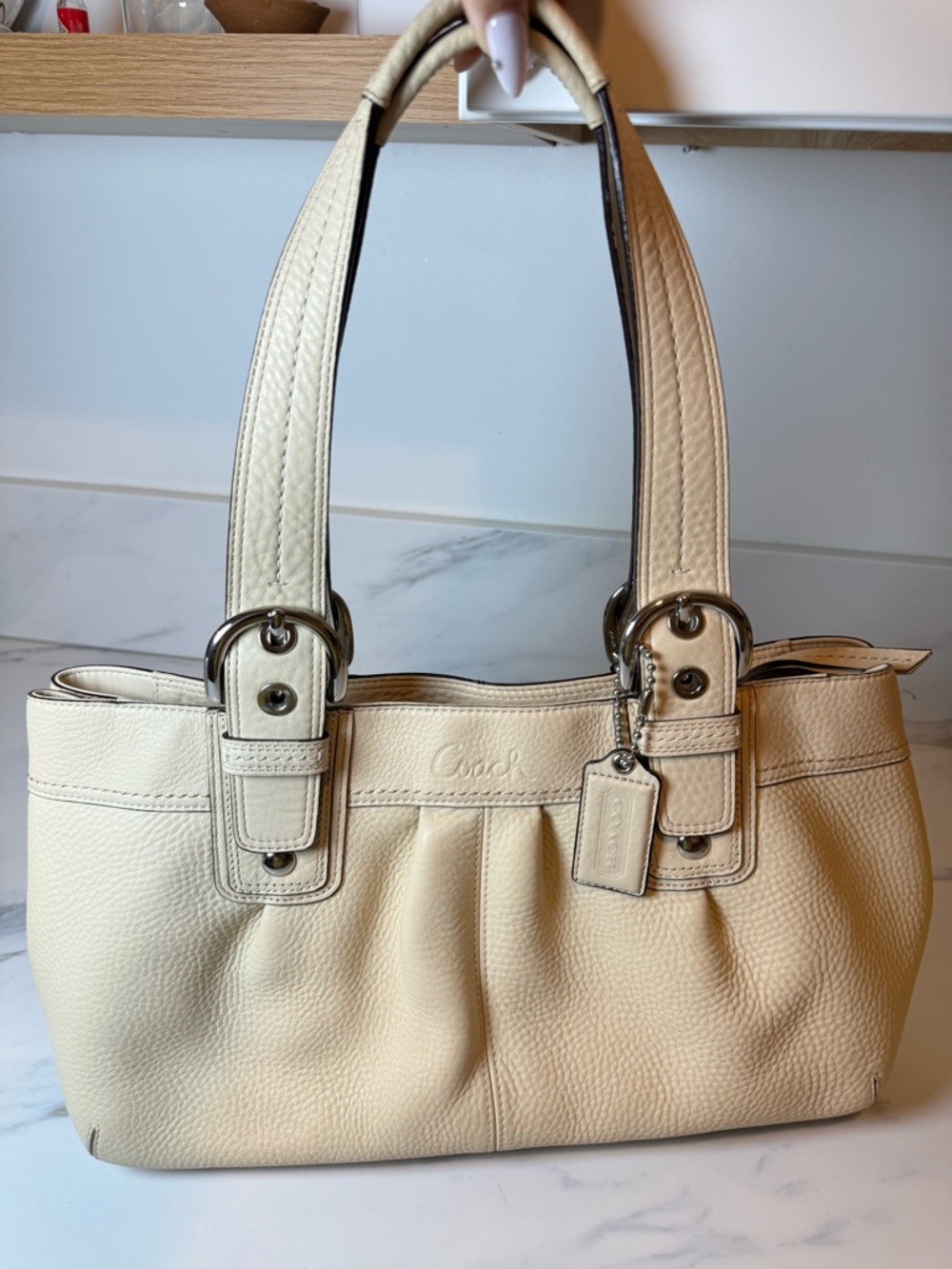 Cream colored vintage pebble leather coach bag